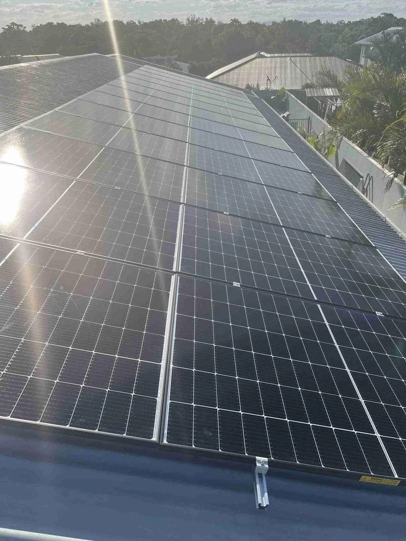 Technician inspecting a rooftop solar system